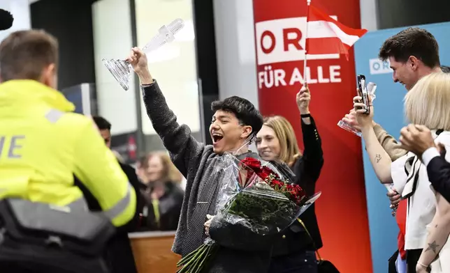 JJ, center, from Austria arrives at the airport in Vienna, Austria, Sunday, May 18, 2025, after winning the Grand Final of the 69th Eurovision Song Contest, in Basel yesterday. (AP Photo/Denes Erdos)