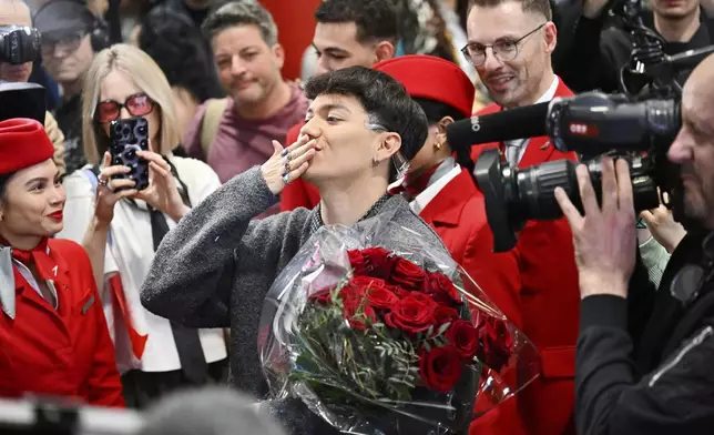 JJ, center, from Austria arrives at the airport in Vienna, Austria, Sunday, May 18, 2025, after winning the Grand Final of the 69th Eurovision Song Contest, in Basel yesterday. (AP Photo/Denes Erdos)