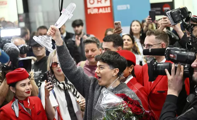 JJ, center, from Austria arrives at the airport in Vienna, Austria, Sunday, May 18, 2025, after winning the Grand Final of the 69th Eurovision Song Contest, in Basel yesterday. (AP Photo/Denes Erdos)