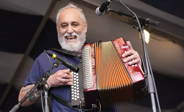 Ron Hodges of The Iguanas performs with the band at the New Orleans Jazz &amp; Heritage Festival in New Orleans, Friday, April 25, 2025. (AP Photo/Gerald Herbert)