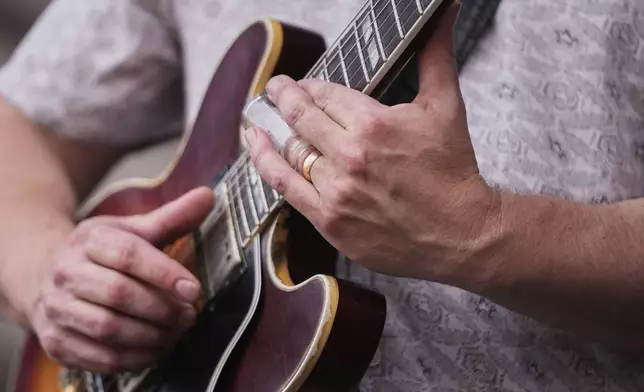 Aaron Wilkinson of The Honey Island Swamp Band performs with the band at the New Orleans Jazz &amp; Heritage Festival in New Orleans, Friday, April 25, 2025. (AP Photo/Gerald Herbert)