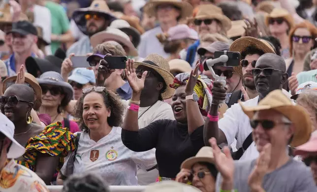 The crowd reacts as Youssou N'Dour performs at the New Orleans Jazz &amp; Heritage Festival in New Orleans, Friday, April 25, 2025. (AP Photo/Gerald Herbert)