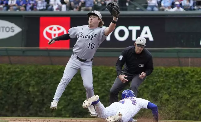Chicago Cubs' Pete Crow-Armstrong, right, steals second base as Chicago White Sox shortstop Chase Meidroth (10) takes the throw during the second inning of a baseball game Saturday, May 17, 2025, in Chicago. (AP Photo/David Banks)
