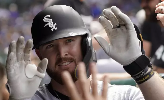 Chicago White Sox's Tim Elko is greeted in the dugout after hitting a home run against the Chicago Cubs during the fifth inning of a baseball game Saturday, May 17, 2025, in Chicago. (AP Photo/David Banks)