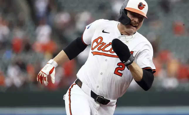 Baltimore Orioles' Gunnar Henderson rounds third base to score a run during the third inning of a baseball game against the Kansas City Royals, Sunday, May 4, 2025, in Baltimore. (AP Photo/Daniel Kucin Jr.)