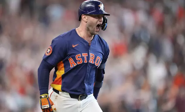 Houston Astros' Christian Walker celebrates after hitting a game-winning two-run home run against the Seattle Mariners during the ninth inning of a baseball game Sunday, May 25, 2025, in Houston. (AP Photo/David J. Phillip)
