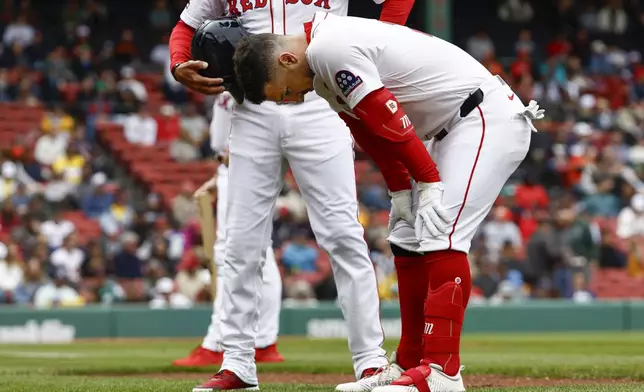 Boston Red Sox's Alex Bregman bends over before leaving the game after injuring himself on a single against the Baltimore Orioles during the fifth inning in the first baseball game of a doubleheader Friday, May 23, 2025, at Fenway Park in Boston. (AP Photo/Winslow Townson)