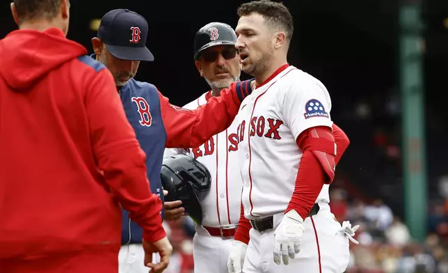 Boston Red Sox manager Alex Cora puts his hand on the shoulder of Alex Bregman as he leaves the game after injuring himself running out a single against the Baltimore Orioles during the fifth inning in the first baseball game of a doubleheader Friday, May 23, 2025, at Fenway Park in Boston. (AP Photo/Winslow Townson)