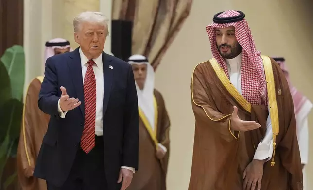 President Donald Trump arrives with Saudi Crown Prince Mohammed bin Salman for the group photo with Gulf Cooperation Council leaders during the GCC Summit in Riyadh, Saudi Arabia, Wednesday, May 14, 2025. (AP Photo/Alex Brandon)