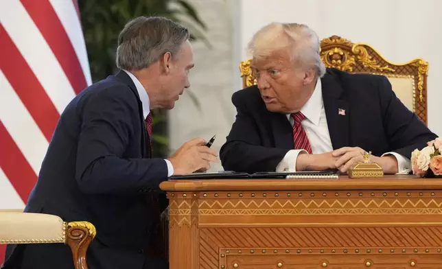 Kelly Ortberg, President and Chief Executive Officer, The Boeing Company, left, speaks President Donald Trump during a signing ceremony at the Amiri Diwan in Doha, Qatar, Wednesday, May 14, 2025. (AP Photo/Alex Brandon)
