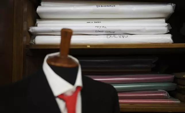 Fabric sits on shelves at the Gammarelli ecclesiastic clothes tailor shop in Rome, Wednesday, April 30, 2025. (AP Photo/Francisco Seco)