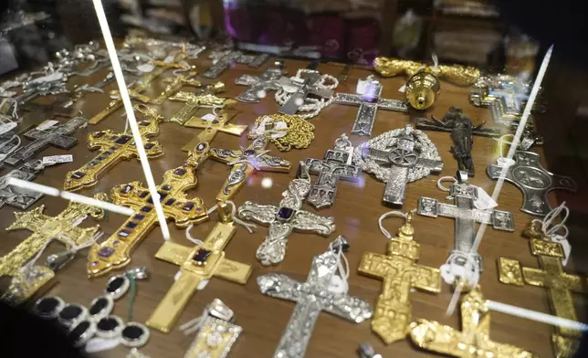 Crosses are displayed inside the shop of Italian tailor Raniero Mancinelli, in Rome, Wednesday, April 30, 2025. (AP Photo/Gregorio Borgia)
