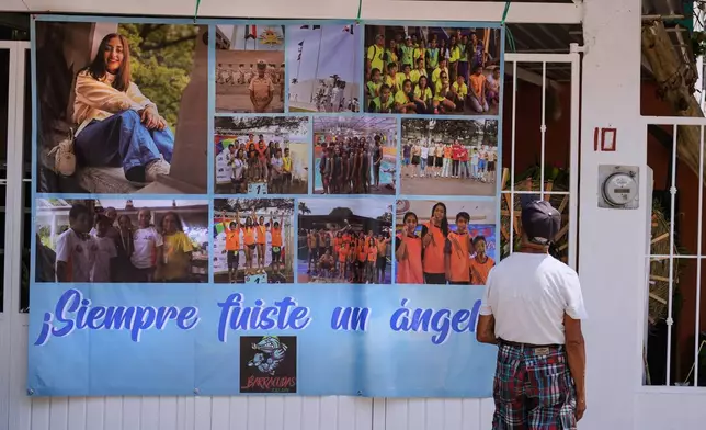 A man looks at a banner with photos of Naval Academy Cadet América Yamilet Sánchez, who died aboard a Mexican Navy sailing ship that collided with the Brooklyn Bridge, in Xalapa, Mexico, Tuesday, May 20, 2025. (AP Photo/Victoria Razo)