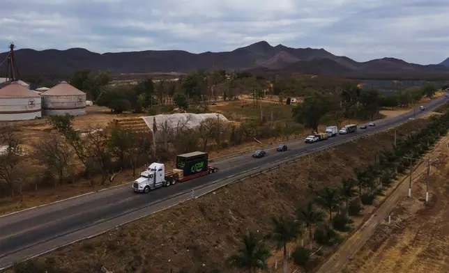 Ostok Sanctuary staff members transport animals in trucks to Mazatlan, Sinaloa state, from the refuge in the outskirts of Culiacan, Sinaloa state, Mexico, Tuesday, May 20, 2025. (AP Photo/Felix Marquez)