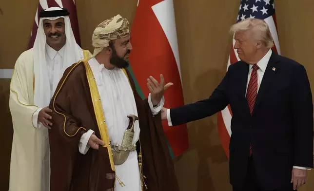 President Donald Trump speaks with Oman's Deputy Prime Minister for International Affairs Al Sayyid Asaad Tariq Taimur Al Said, center, and Qatar's Emir Sheikh Tamim bin Hamad Al Thani as they arrive to attend a group photo with Gulf Cooperation Council leaders during the GCC Summit in Riyadh, Saudi Arabia, Wednesday, May 14, 2025. (AP Photo/Alex Brandon)