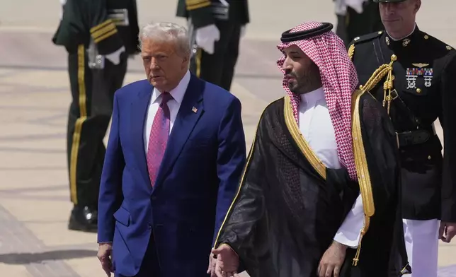 President Donald Trump speaks with Saudi Crown Prince Mohammed bin Salman during an arrival ceremony at the Royal Terminal of King Khalid International Airport in Riyadh, Saudi Arabia, Tuesday, May 13, 2025. (AP Photo/Alex Brandon)