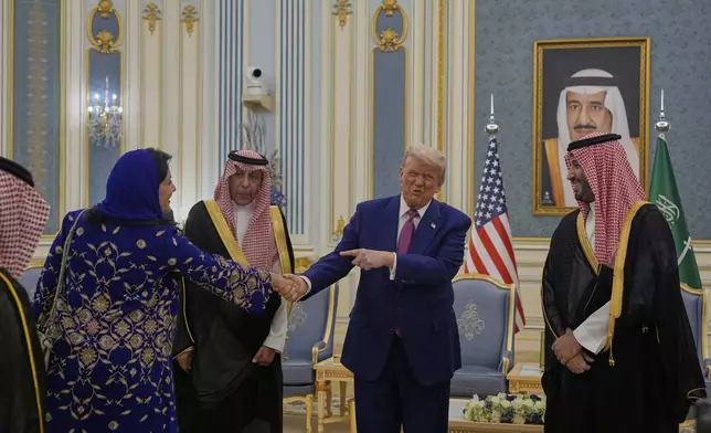 President Donald Trump gestures to Saudi Crown Prince Mohammed bin Salman as he greets Reema bint Bandar Al Saud, Saudi ambassador to the United States, at the Royal Palace in Riyadh, Saudi Arabia, Tuesday, May 13, 2025 (AP Photo/Alex Brandon)