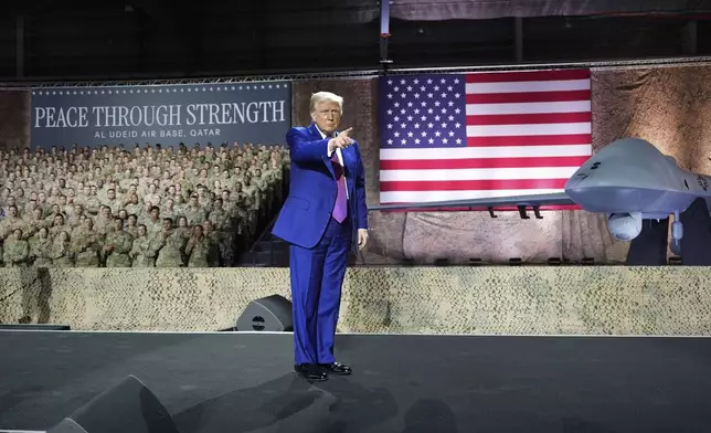 President Donald Trump gestures on stage at the Al Udeid Air Base, Thursday, May 15, 2025, in Doha, Qatar. (AP Photo/Alex Brandon)