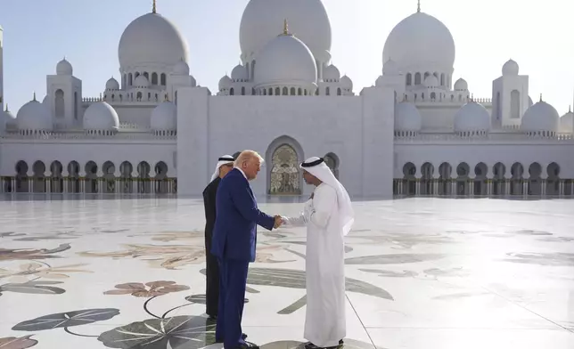 President Donald Trump shakes hands with with Yousif Al Obaidli, director of Sheikh Zayed Grand Mosque, during a tour of the Sheikh Zayed Grand Mosque, Thursday, May 15, 2025, in Abu Dhabi, United Arab Emirates. (AP Photo/Alex Brandon)