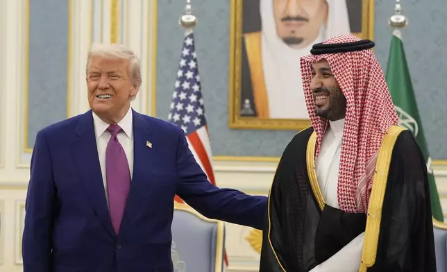 President Donald Trump and Saudi Crown Prince Mohammed bin Salman gesture as they meet delegations at the Royal Palace in Riyadh, Saudi Arabia, Tuesday, May 13, 2025. (AP Photo/Alex Brandon)