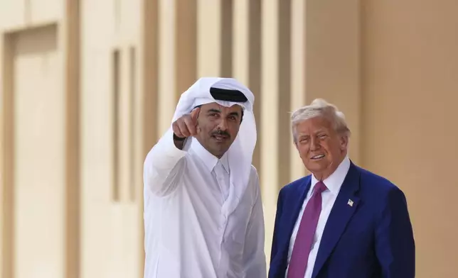 Qatar's Emir Sheikh Tamim bin Hamad Al Thani gestures next to President Donald Trump at Al Udeid Air Base, Thursday, May 15, 2025, in Doha, Qatar. (AP Photo/Alex Brandon)