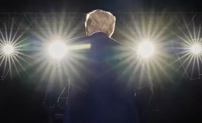 President Donald Trump smiles on stage at the Al Udeid Air Base, Thursday, May 15, 2025, in Doha, Qatar. (AP Photo/Alex Brandon)