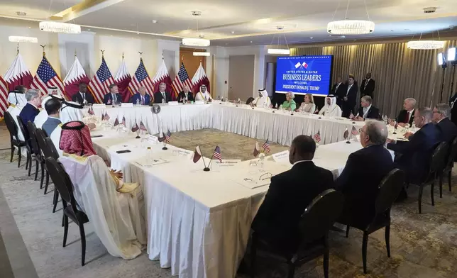President Donald Trump speaks, seated between Kelly Ortberg President and CEO of Boeing, left, and Larry Culp, CEO of GE Aerospace during a business roundtable, in the presence of Sheikh Saoud bin Abdulrahman bin Hassan bin Ali Al Thani, Deputy Prime Minister and Minister of State for Defense Affairs, left, Thursday, May 15, 2025, in Doha, Qatar. (AP Photo/Alex Brandon)