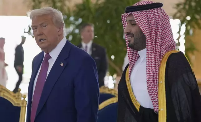 President Donald Trump speaks with Saudi Crown Prince Mohammed bin Salman during an arrival ceremony at the Royal Terminal of King Khalid International Airport in Riyadh, Saudi Arabia, Tuesday, May 13, 2025. (AP Photo/Alex Brandon)