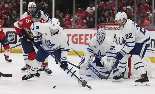 Toronto Maple Leafs center Steven Lorentz (18) goes for the puck against Florida Panthers center Anton Lundell (15) during the first period in Game 6 of a second-round NHL hockey playoff series, Friday, May 16, 2025, in Sunrise, Fla. (AP Photo/Lynne Sladky)
