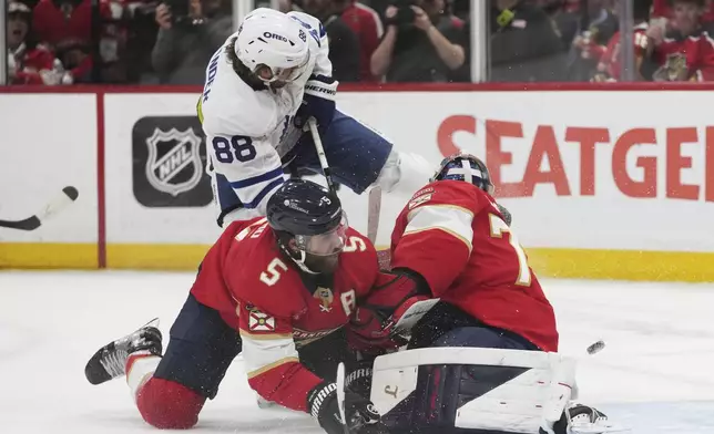 Florida Panthers defenseman Aaron Ekblad (5) and goaltender Sergei Bobrovsky, right, defend the goal against Toronto Maple Leafs right wing William Nylander (88) during the second period in Game 6 of a second-round NHL hockey playoff series, Friday, May 16, 2025, in Sunrise, Fla. (AP Photo/Lynne Sladky)
