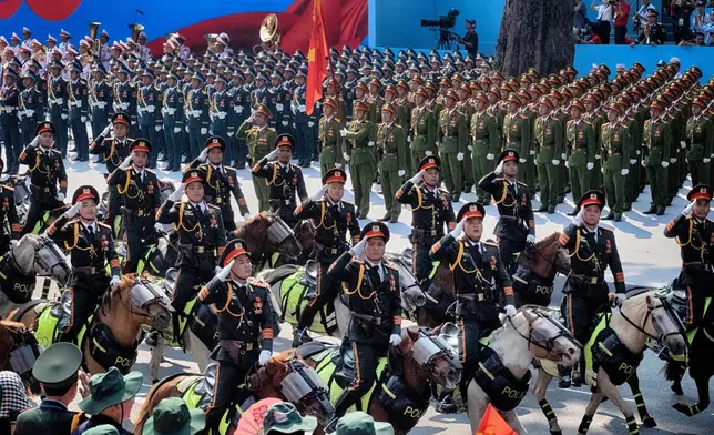 A Vietnamese equestrian unit parades past officials during the 50th anniversary celebration of the end of the Vietnam War on Wednesday, April 30, 2025, in Ho Chi Minh City, Vietnam. (AP Photo/Richard Vogel)