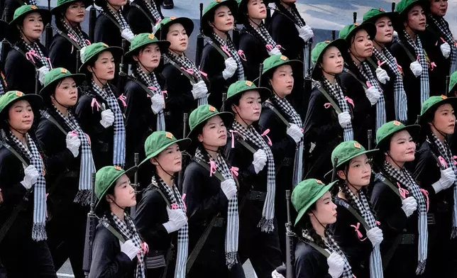 Women soldiers in North Vietnamese Army costumes march during a parade celebrating the 50th anniversary of the end of the war on Wednesday, April 30, 2025, in Ho Chi Minh City, Vietnam. (AP Photo/Richard Vogel)