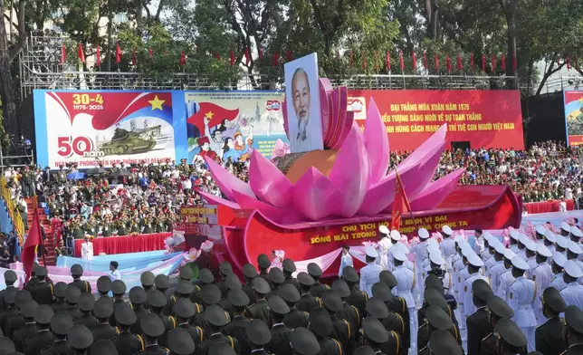 A float carrying a portrait of the late Vietnamese revolutionary leader Ho Chi Minh takes part in a parade during the 50th anniversary celebration of the end of the Vietnam War Wednesday, April 30, 2025, in Ho Chi Minh City, Vietnam. (AP Photo/Achmad Ibrahim)