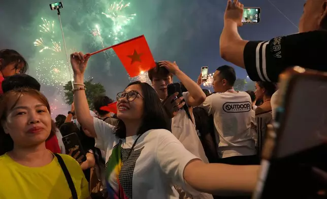 People watch a fireworks display during celebrations for the 50th anniversary of the end of the Vietnam War in Ho Chi Minh City, Vietnam, Wednesday, April 30, 2025. (AP Photo/Achmad Ibrahim)