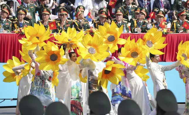 Vietnamese dancers perform during a parade celebrating the 50th anniversary of the end of the Vietnam War in Ho Chi Minh City, Vietnam, Wednesday, April 30, 2025. (AP Photo/Achmad Ibrahim)