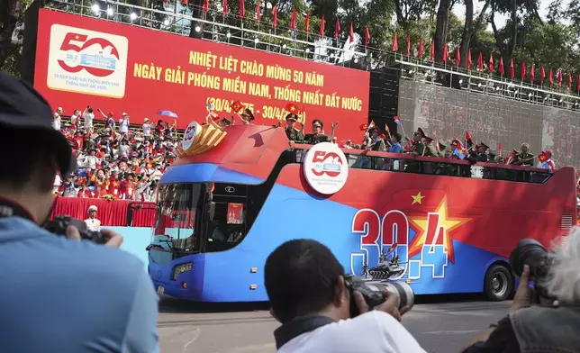 Vietnam War veterans on an open bus take part in a parade to commemorate the 50th anniversary of the end of the Vietnam War in Ho Chi Minh City Wednesday, April 30, 2025. (AP Photo/Hau Dinh)