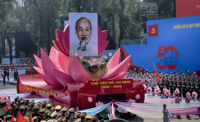 A parade float carrying a portrait of Vietnamese leader Ho Chi Minh takes part in a military parade during the 50th anniversary celebration of the end of the Vietnam War on Wednesday, April 30, 2025, in Ho Chi Minh City, Vietnam. (AP Photo/Richard Vogel)