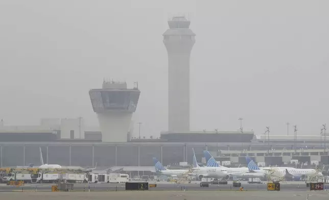 Fog covers planes and control towers at Newark Liberty International Airport in Newark, N.J., Monday, May 5, 2025. (AP Photo/Seth Wenig)