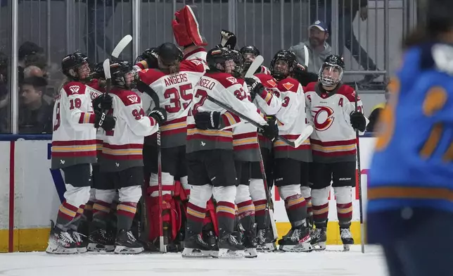 Members of the Ottawa Charge celebrate their win over the Toronto Sceptres during overtime in a PWHL hockey game in Toronto, Saturday, May 3, 2025. (Arlyn McAdorey/The Canadian Press via AP)