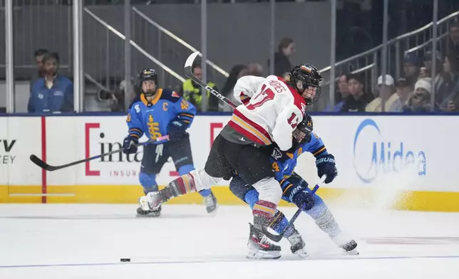 Ottawa Charge's Gabbie Hughes (17) and Toronto Sceptres' Renata Fast (14) collide during the third period of a PWHL hockey game in Toronto, Saturday, May 3, 2025. (Arlyn McAdorey/The Canadian Press via AP)