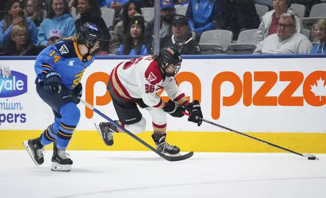 Ottawa Charge's Emily Clark (26) skates with the puck as Toronto Sceptres' Renata Fast (14) follows during overtime in a PWHL hockey game in Toronto, Saturday, May 3, 2025. (Arlyn McAdorey/The Canadian Press via AP)