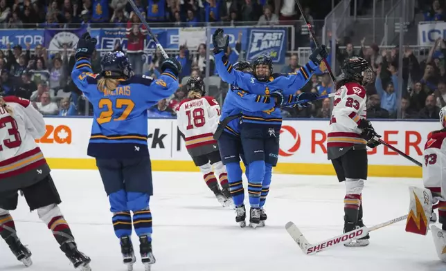 Toronto Sceptres' Sarah Nurse (20) is congratulated by teammates after scoring a goal against the Ottawa Charge during the second period of a PWHL hockey game in Toronto, Saturday, May 3, 2025. (Arlyn McAdorey/The Canadian Press via AP)
