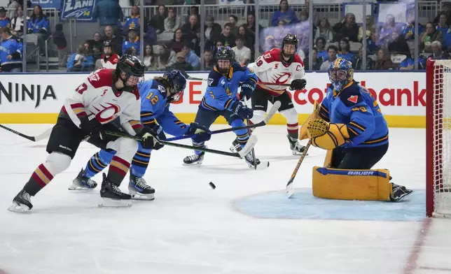 Ottawa Charge's Shiann Darkangelo (27) and Brianne Jenner (19) attack as Toronto Sceptres' Allie Munroe (12), Kali Flanagan (6) and goaltender Kristen Campbell (50) defend the net during the third period of a PWHL hockey game in Toronto, Saturday, May 3, 2025. (Arlyn McAdorey/The Canadian Press via AP)