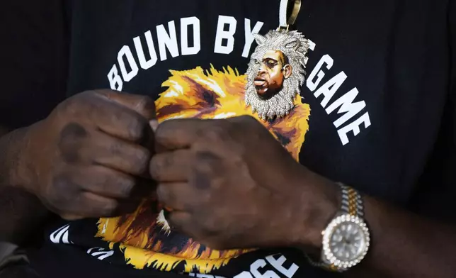 George Floyd's brother, Philonise Floyd, wears a pendent of his brother's face with a lion during a memorial service on the anniversary of Floyd's death on Sunday, May 25, 2025, in Houston. (AP Photo/Ashley Landis)