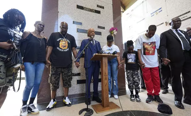Rev. Al Sharpton, center, prays with family members of George Floyd during a memorial service on the anniversary of Floyd's death on Sunday, May 25, 2025, in Houston. (AP Photo/Ashley Landis)