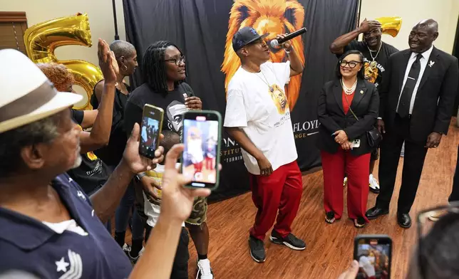 George Floyd's sister, LeTonya Floyd, center, sings during a family celebration at Floyd's childhood housing project on the anniversary of Floyd's death on Sunday, May 25, 2025, in Houston. (AP Photo/Ashley Landis)