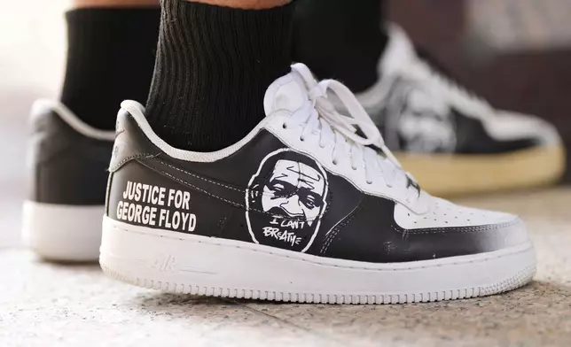 George Floyd's niece, Bianca Williams wears shoes with her uncle's face during a memorial service on the anniversary of Floyd's death on Sunday, May 25, 2025, in Houston. (AP Photo/Ashley Landis)