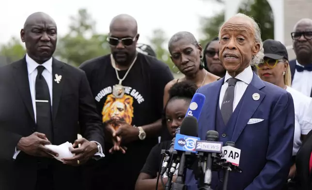 Rev. Al Sharpton, right, speaks at a press conference surrounded by George Floyd's family and public officials after a memorial service on the anniversary of Floyd's death on Sunday, May 25, 2025, in Houston. (AP Photo/Ashley Landis)