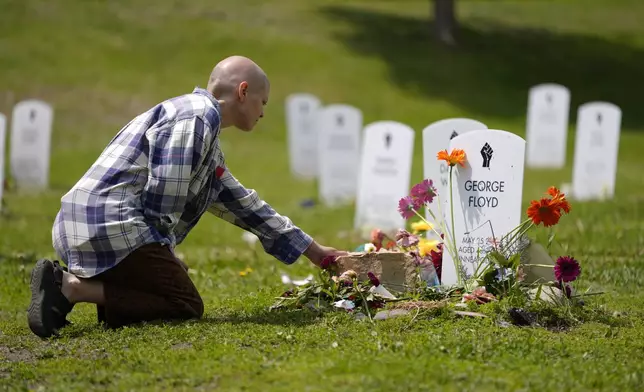 A woman reacts near the tribute to George Floyd's at the Say Their Names Cemetery on the five-year anniversary of Floyd's death, Sunday, May 25, 2025, in Minneapolis. (AP Photo/Abbie Parr)