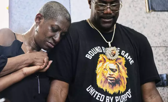 Zsa Zsa Floyd, left, sister of George Floyd, and brother Philonise Floyd pray during a memorial service on the anniversary of Floyd's death on Sunday, May 25, 2025, in Houston. (AP Photo/Ashley Landis)